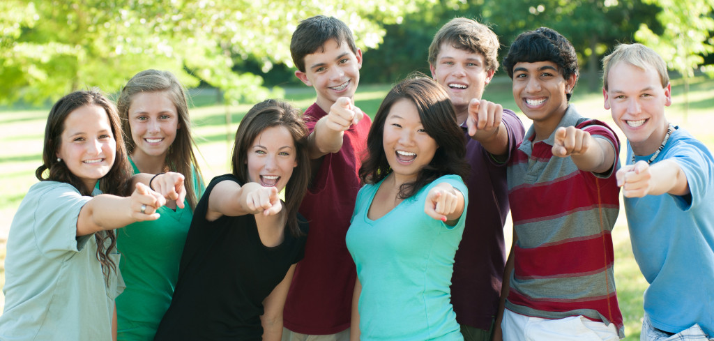 Ethnic Group of happy teenage friends outside